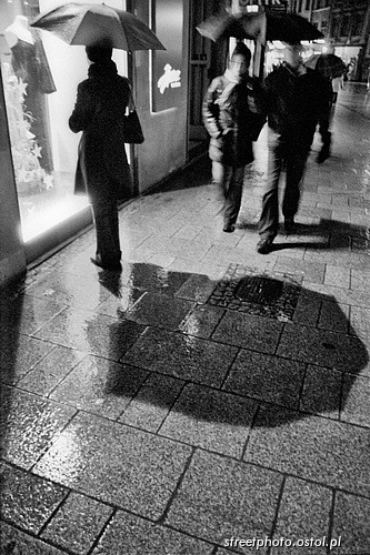 Kobieta z parasolką, Kraków, Grodzka, witryna sklepowa, miasto nocą.